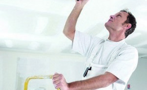 craftsman painting the ceiling