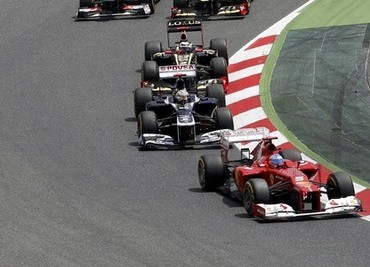 Ferrari Formula One driver Alonso leads during the first lap of the Spanish F1 Grand Prix at the Circuit de Catalunya in Montmelo
